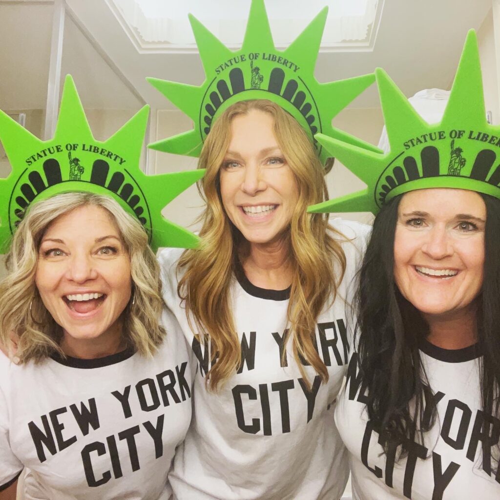 three ladies wearing statue of liberty foam hats with new york city t-shirts on