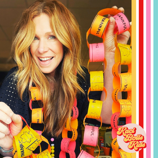 Thanksgiving Paper chain: Smiling lady holding a paper thankful chain, or gratitude chain