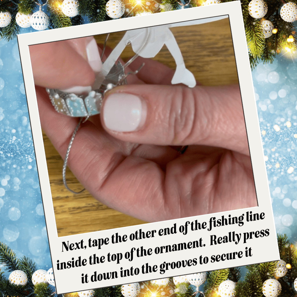  taping the fishing line into the top of the ornament