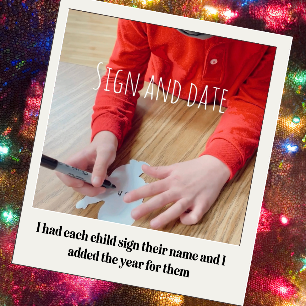 easy-kindergarten-craft child signing their name the ornament