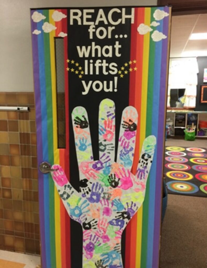 Classroom-door-decor:  Reach for what lifts you - large hand with handprints
